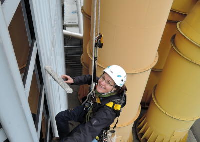 Industriekletterer bei Glasreinigung am hängenden Seil, Arbeit in der Höhe